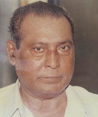 Chadayan Govindan wearing a white polo shirt