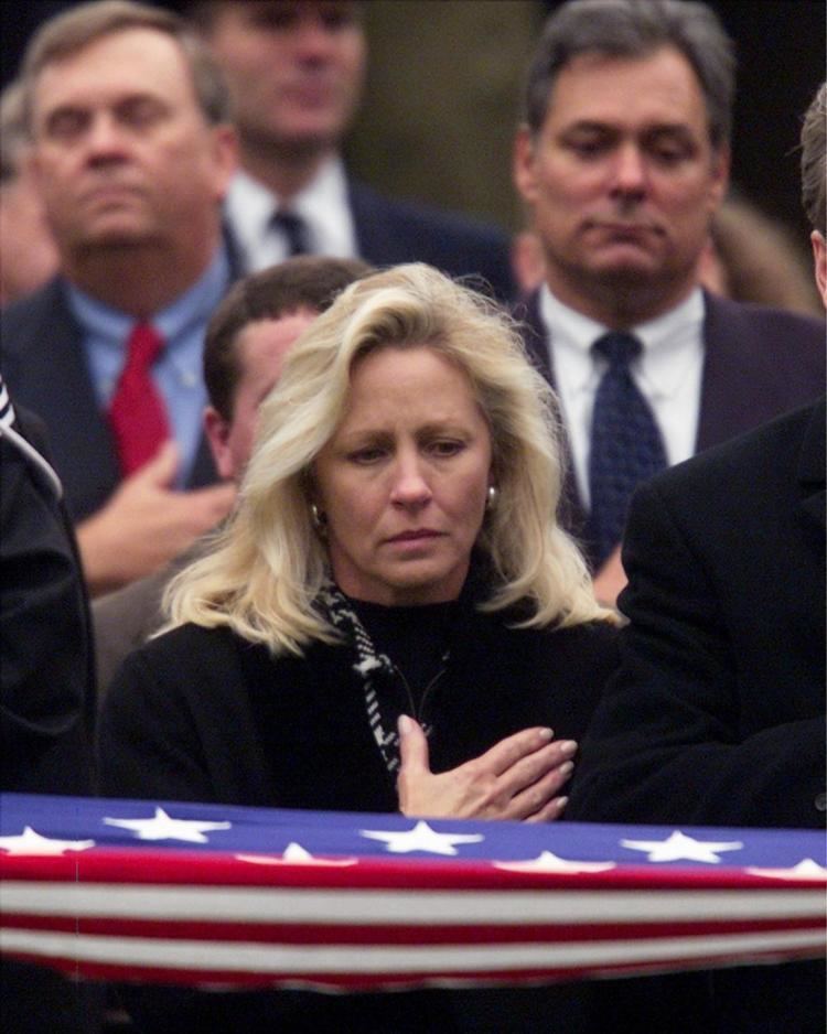 Sheri Burlingame, widow of Charles Frank Burlingame III, saluting during the funeral service for her husband