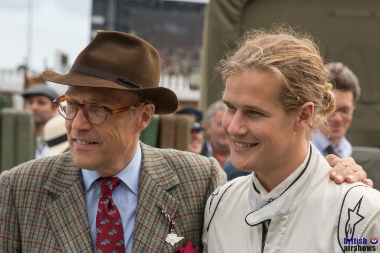 Charles Gordon-Lennox, 11th Duke of Richmond smiling with Lord Settrington while looking afar