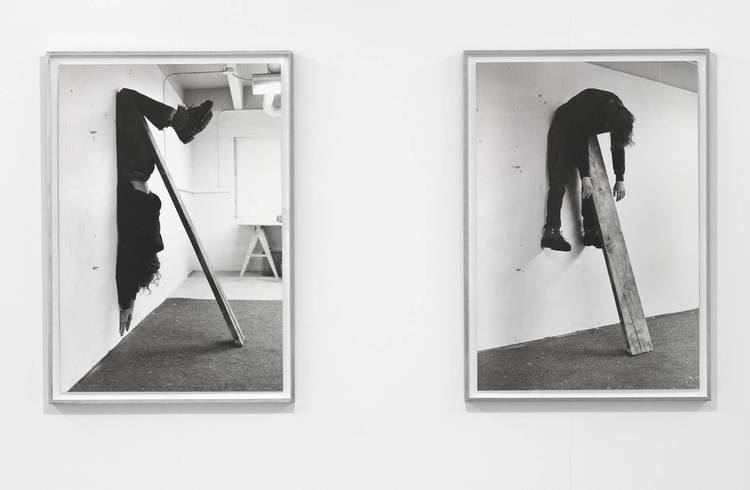 Plank piece I and II, 1973, by Charles Ray. Charles hanging in the air draped over a plank of wood that leans against a wall