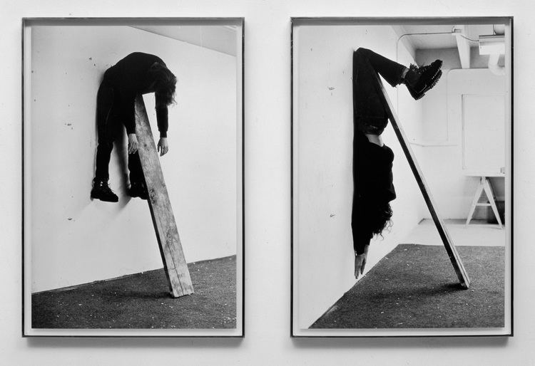 Plank piece I and II, 1973, by Charles Ray. Charles hanging in the air draped over a plank of wood that leans against a wall