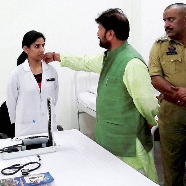 Chaudhary Lal Singh Jammu and Kashmir BJP Minister Chaudhary Lal Singh touches woman