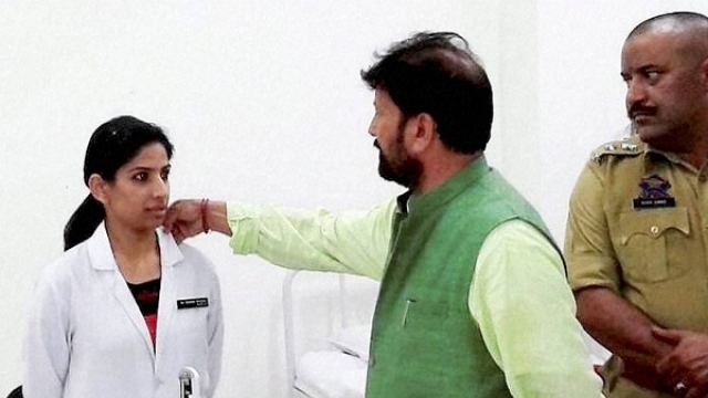 Chaudhary Lal Singh Jammu and Kashmir BJP Minister Chaudhary Lal Singh touches woman