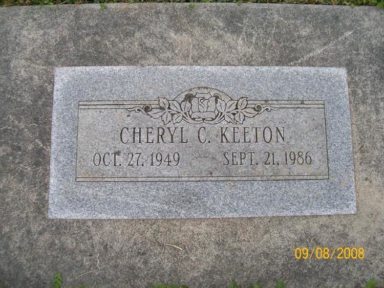 In the picture is the tombstone of Cheryl Keeton in Bunker Hill, Cowlitz Country, Washington, USA. It has her name, birth date, and her death date with a bird design.