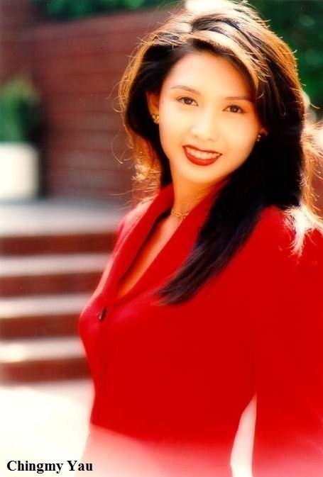 Chingmy Yau smiling while wearing a red long sleeve, gold necklace, and earrings