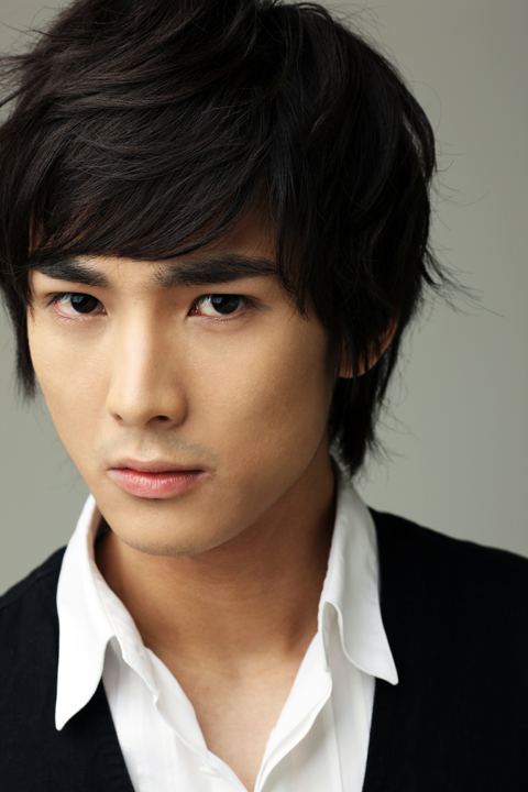 Choi Woo-hyuk wearing a black vest and white long sleeves