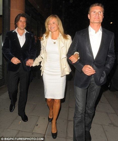Amanda Holden smiling with his husband Chris Hughes, and their friend, David Coulthard at Cipriani restaurant in London