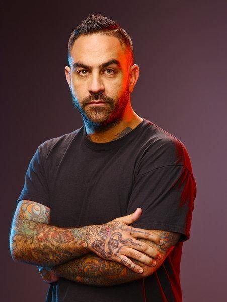 Chris Núñez wearing black t-shirt while his arms crossed