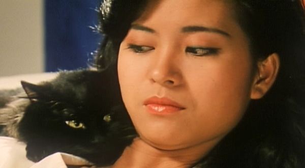 Christine Ng as Pai So with a black cat in a movie scene from The Cat, a 1992 film.