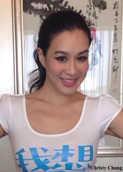 Christy Chung smiling while wearing a white and blue blouse