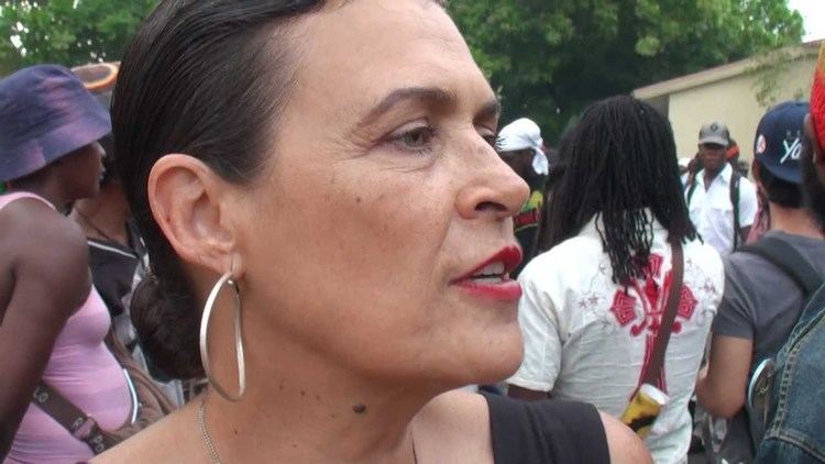 Cindy Breakspeare wearing earrings and a black top.