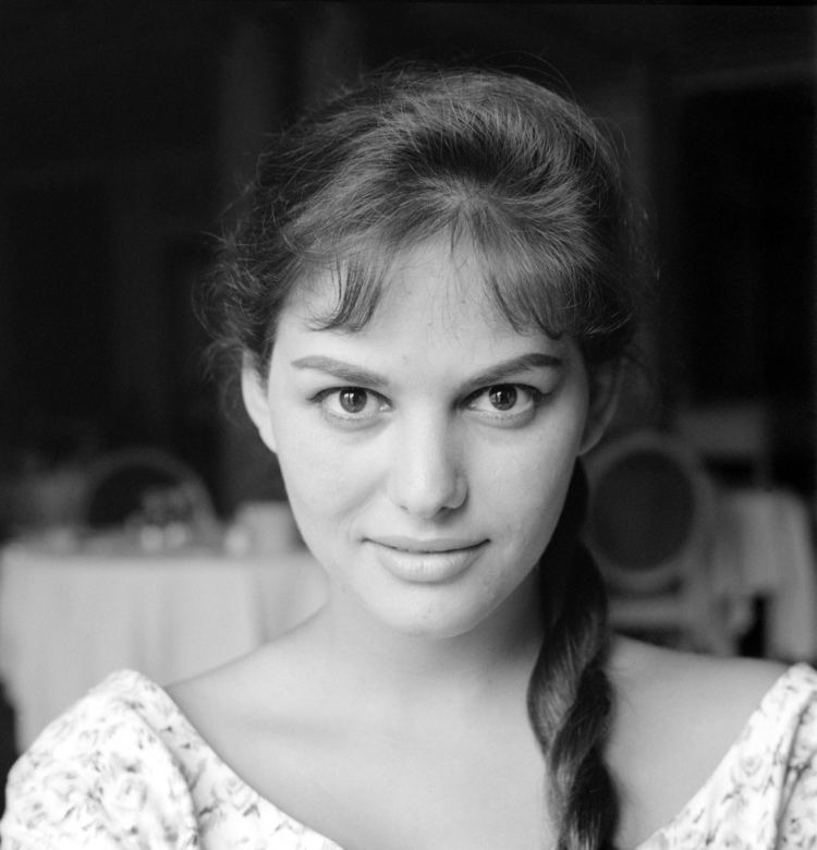 Claudia Cardinale smiling while wearing a floral blouse