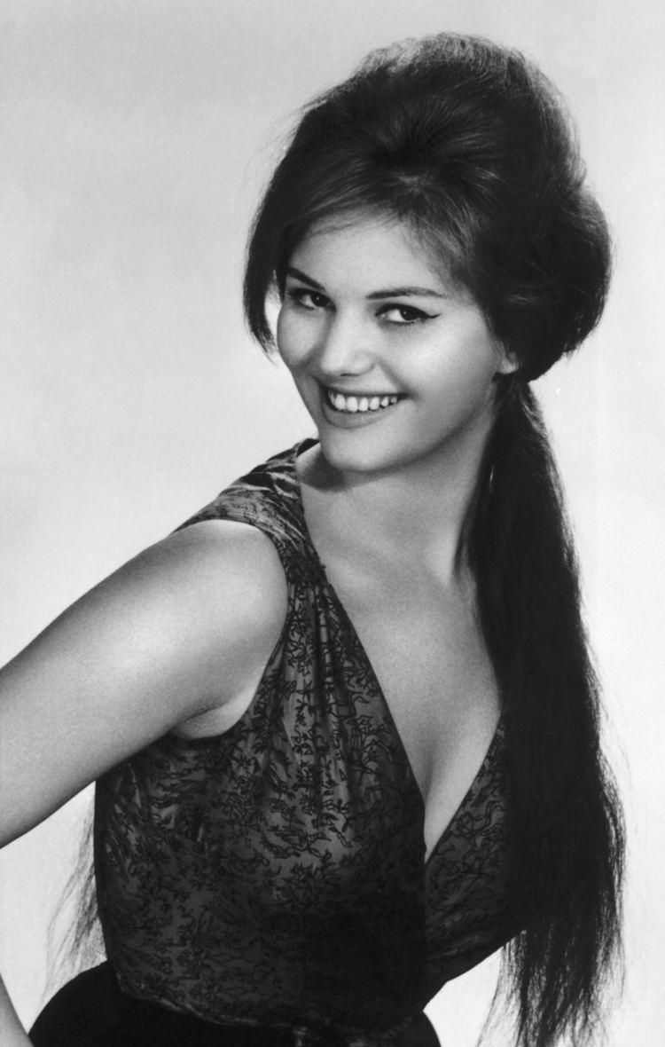 Claudia Cardinale smiling while wearing a floral blouse