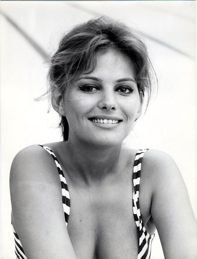 Claudia Cardinale smiling while wearing a striped blouse