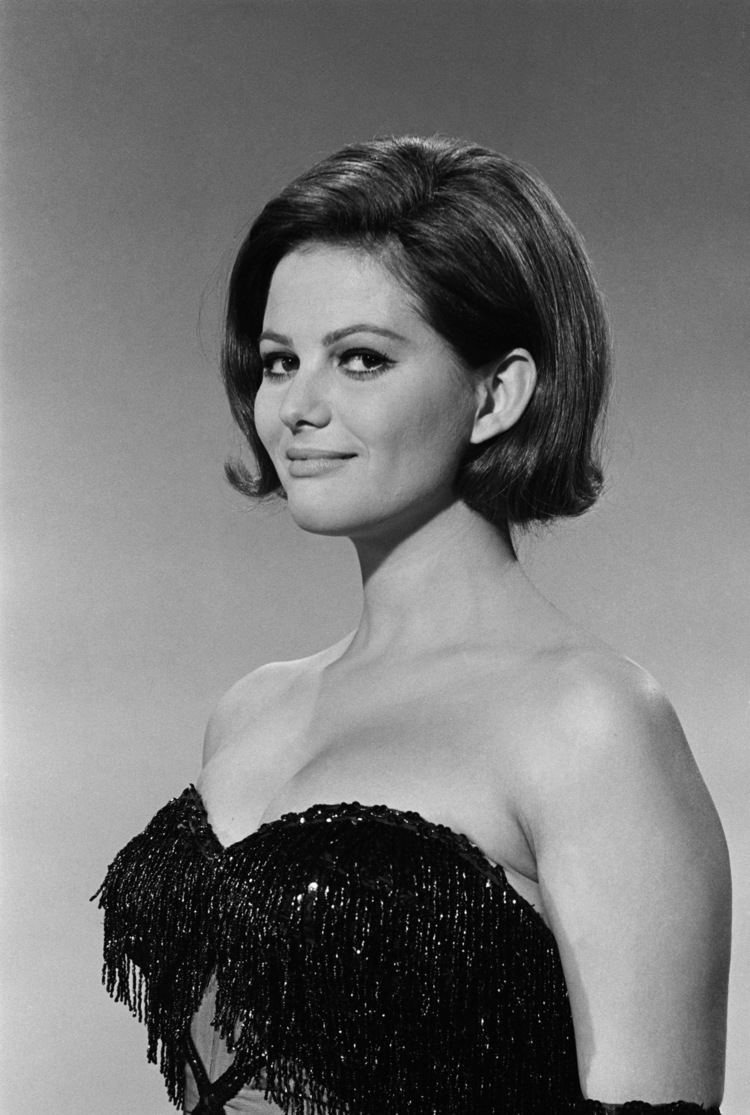 Claudia Cardinale smiling while wearing a black sparkly dress