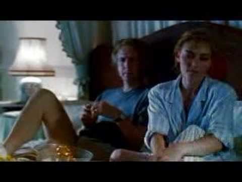 Alan Rickman sitting on the bed while looking at Saskia Reeves in a scene from the 1991 film, Close My Eyes