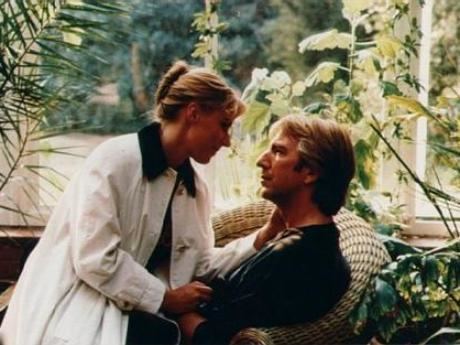 Saskia Reeves sitting at Alan Rickman's lap while she is wearing a white jacket in a scene from the 1991 film, Close My Eyes