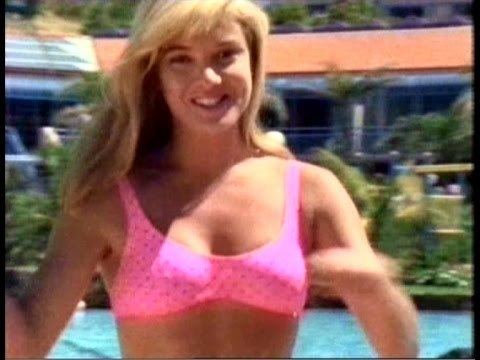 Collette Roberts smiles while wearing a pink bra on a resort | Courtesy of YouTube