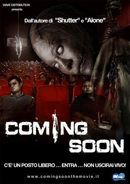 A movie poster of the 2008 Thai Horror film "Coming Soon" showing dead bodies sitting in a movie theater and a ghost tied by the neck