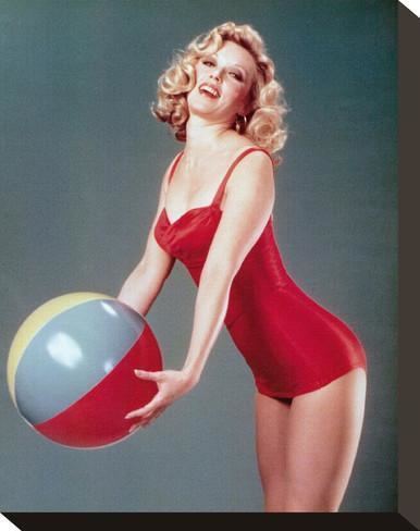 Constance Forslund holding a ball in her red sexy outfit