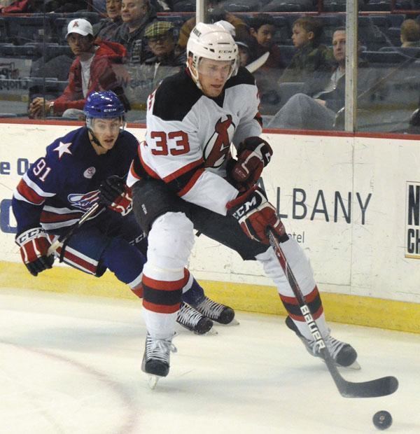 Corbin McPherson Albany Devils Corbin McPherson 33 keeps the puck away from