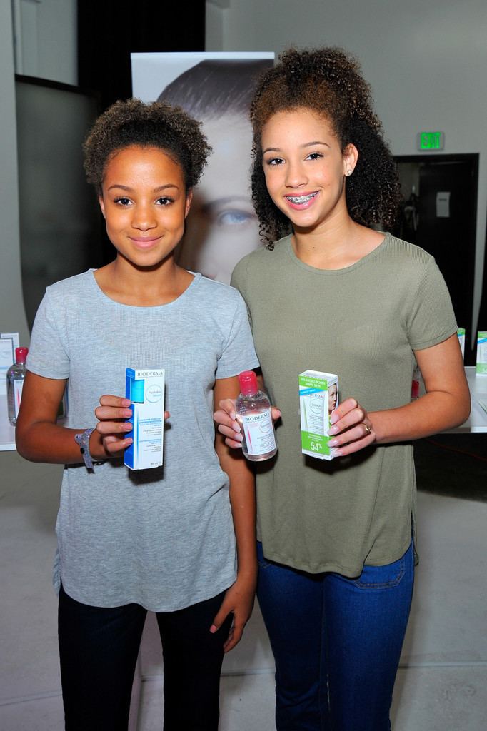 Corinne Massiah smiling together with her twin sister, Halle Massiah during the Kari Feinstein's Style Lounge in Los Angeles California