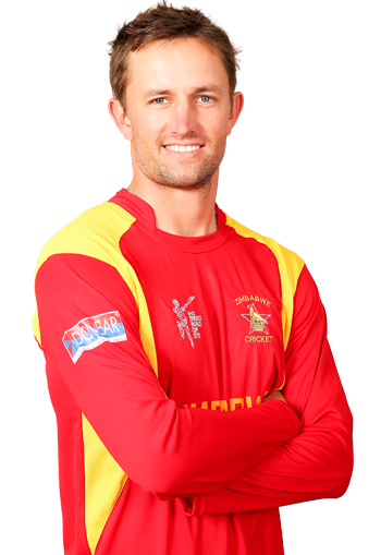 Craig Ervine Is smiling, has brown hair, a beard, and a mustache, arms crossed, and wears his red-yellow National Cricket team uniform with a print on his left chest “ZIMBABWE CRICKET” and another print "DONEAR" on his right arm, and "ZIMBABWE" on his stomach.