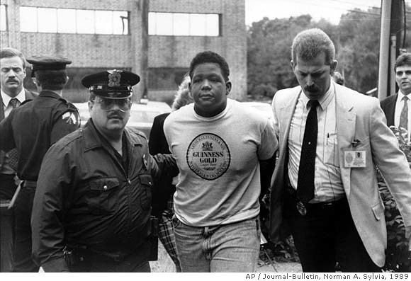 Craig Price being arrested by the police officers while wearing a t-shirt and pants