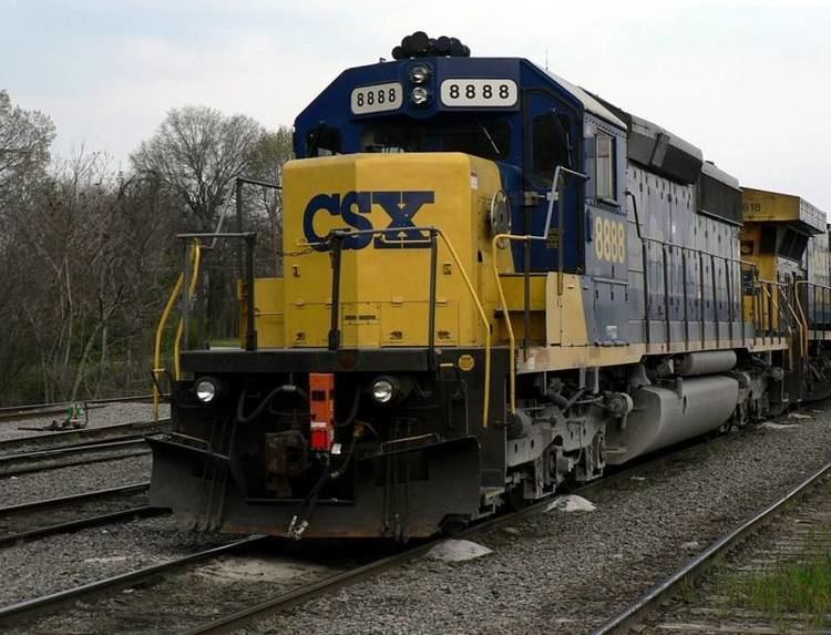 A yellow and blue CSX 8888 railway engine on the railroad