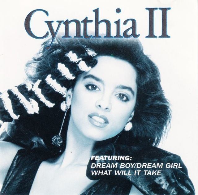 Cynthia on her second studio album while wearing gloves and black blouse
