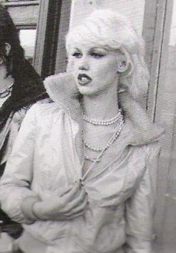 Cyrinda Foxe wearing jacket and necklace