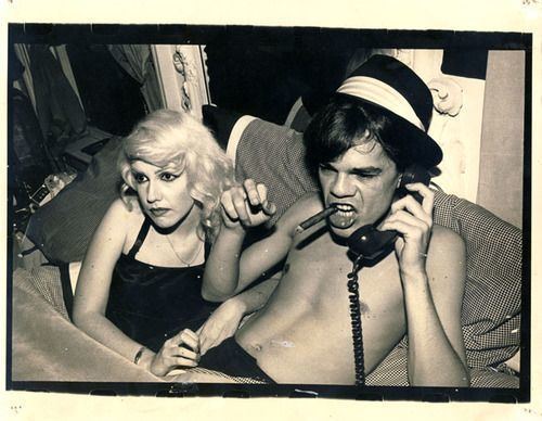 Cyrinda Foxe wearing black top and David Johansen holding the telephone and wearing hat