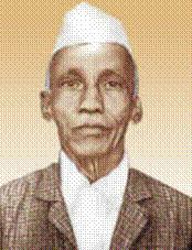 Portrait of D. R. Kaprekar wearing a white cap, brown checkered coat, and white long sleeves