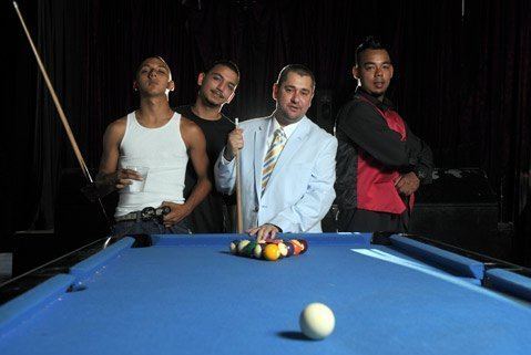 The Santa Barabara Hip-hop members-Lil Bams, Kidd, Damizza, and Fresh (left to right) standing behind a pool table