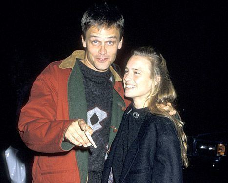 Robin Wright smiling and wearing a black jacket while Dane Witherspoon wearing an orange jacket and black inner shirt