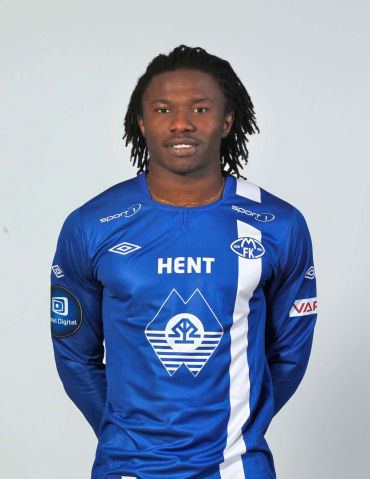 Daniel Chima Chukwu smiling while wearing a white and blue long sleeve jersey