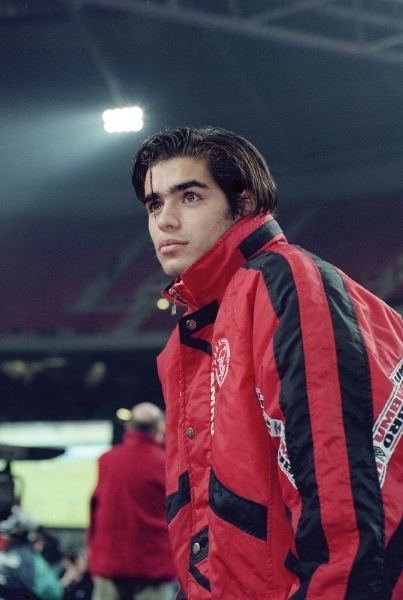 Daniel da Cruz Carvalho looking afar while wearing a black and red jacket