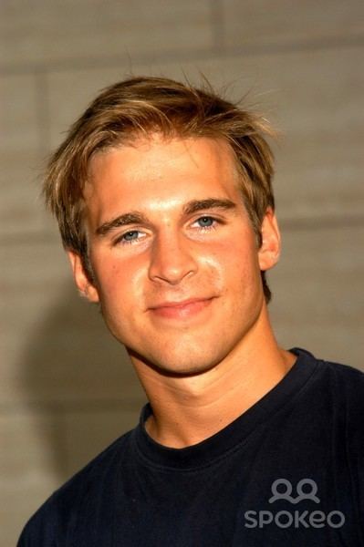 Daniel Letterle smiles while wearing a dark blue shirt