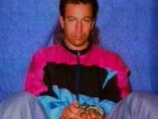 Daniel Pearl wearing a pink,black and blue jacket and gray pants