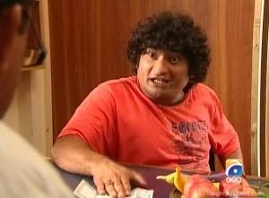 Danish Nawaz with curly hair and wearing an orange t-shirt