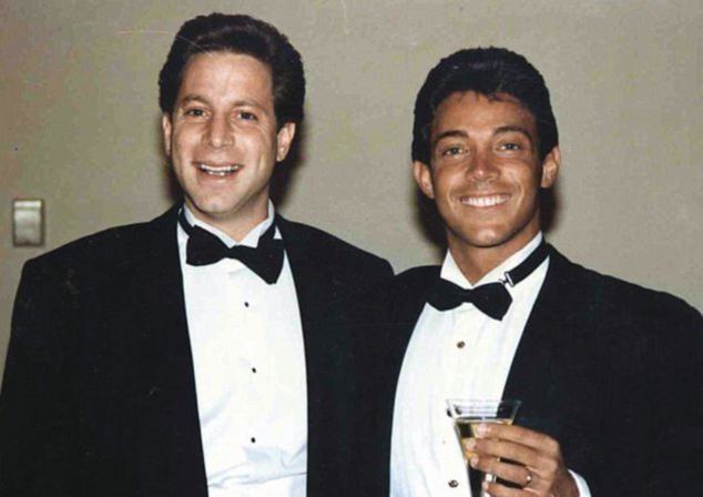 Danny Porush and Jordan Ross Belfort both wearing a black suit and a bow and tie while Belfort holding a glass of champagne.