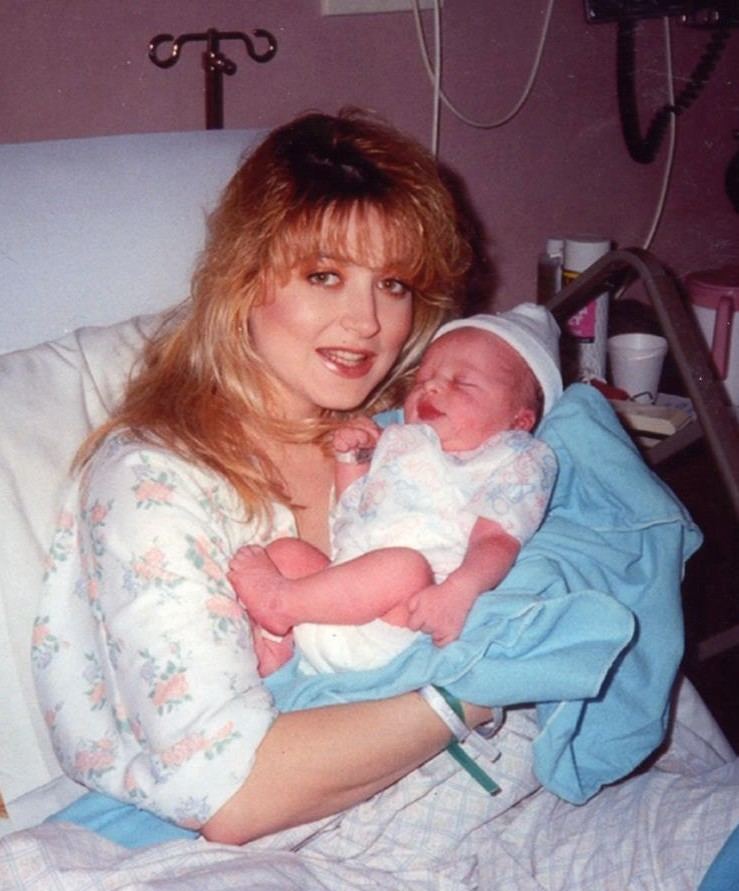 Darlie Routier smiling while carrying her newborn baby