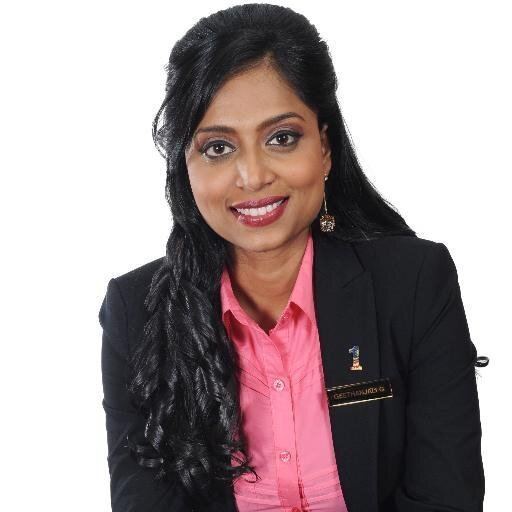 Dato Geethanjali wearing a pink shirt and a black suit