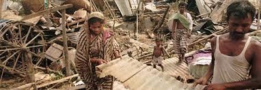 People examining the devastation left after the Daulatpur–Saturia tornado in Bangladesh.