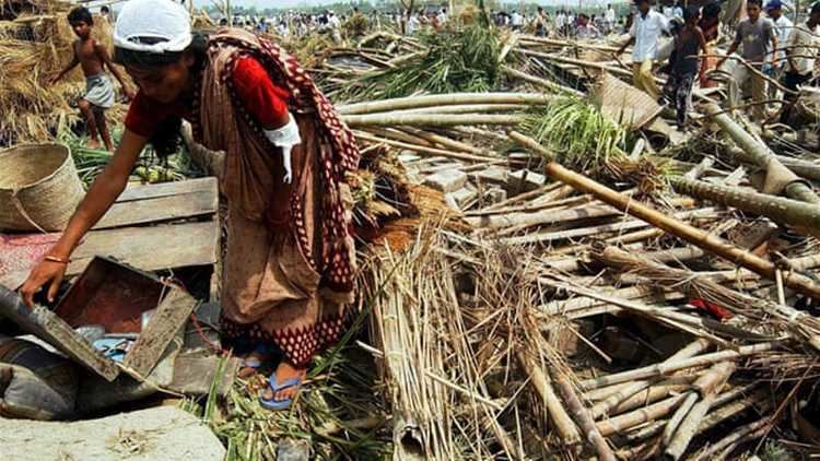 People examining the devastation left after the Daulatpur–Saturia tornado in Bangladesh.