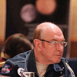 David A. Hardy's candid shot while wearing eyeglasses and black jacket