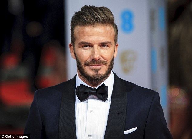 David Beckman David Beckham dazzles on the red carpet as he presents an