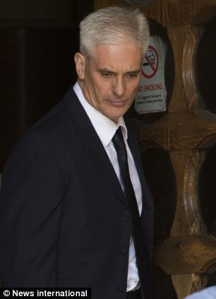 David Hunt wearing black coat, white long sleeves and black neck tie