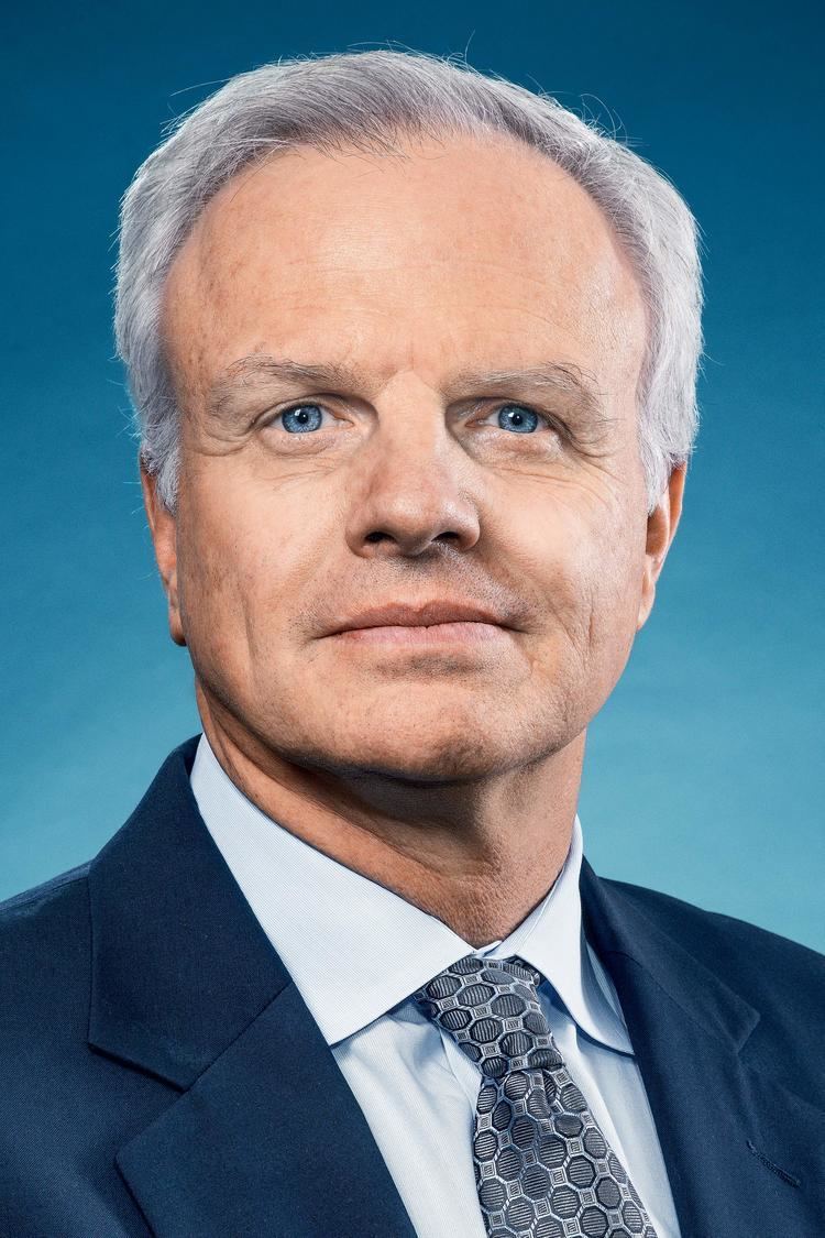 David Neeleman wearing a blue suit with a tie.