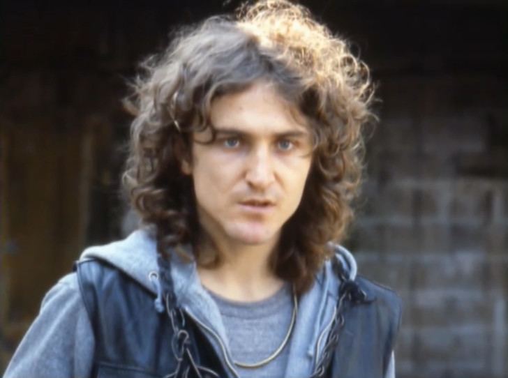 A younger David Patrick Kelly as Luther with long hair and wearing a blue jacket and shirt in a scene from the movie The Warriors, 1979.